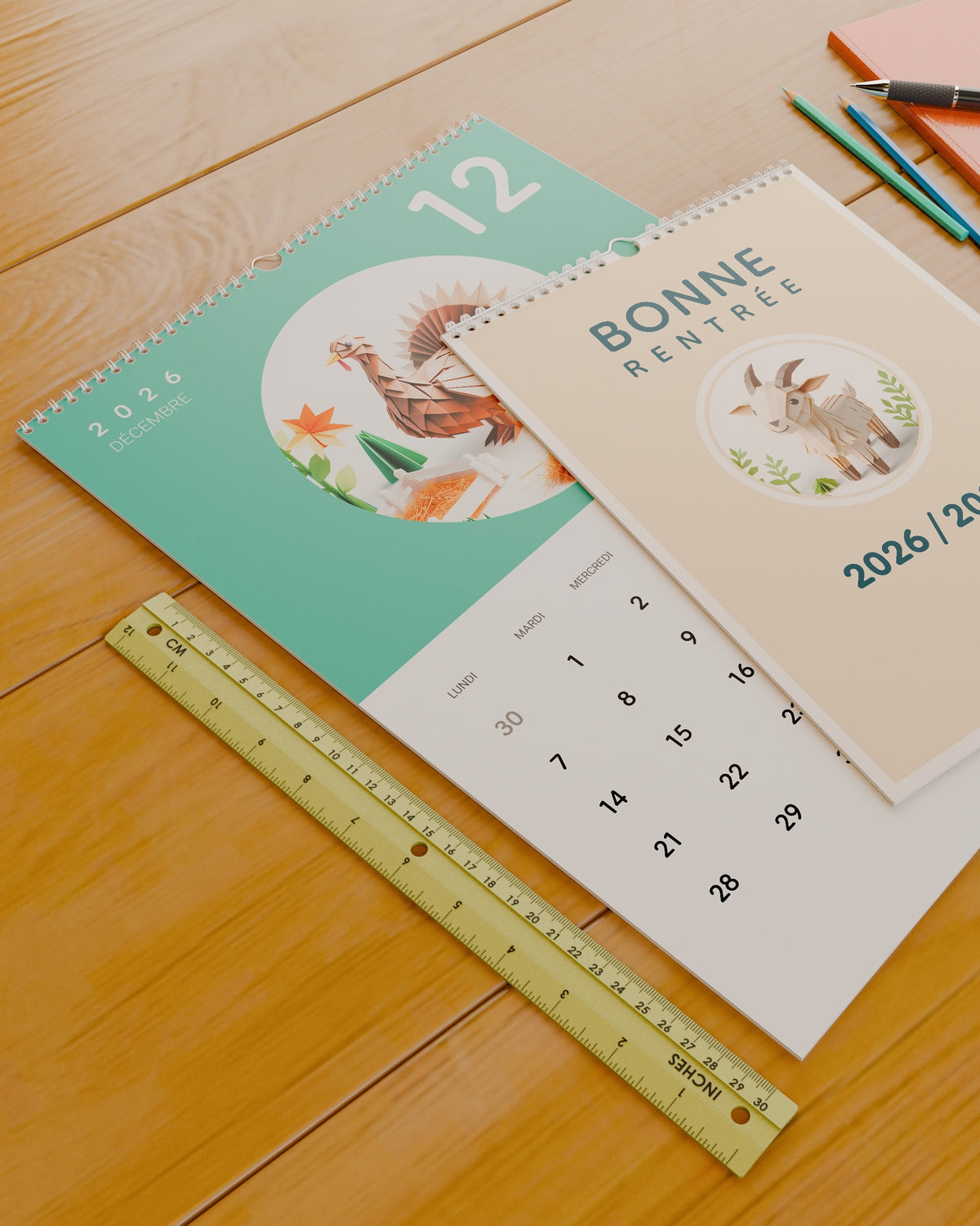 Calendrier mural Bonne Rentrée 2026 / 2027 posé sur un bureau à côté d'une règle de 30 cm, pour donner un repère d'échelle.